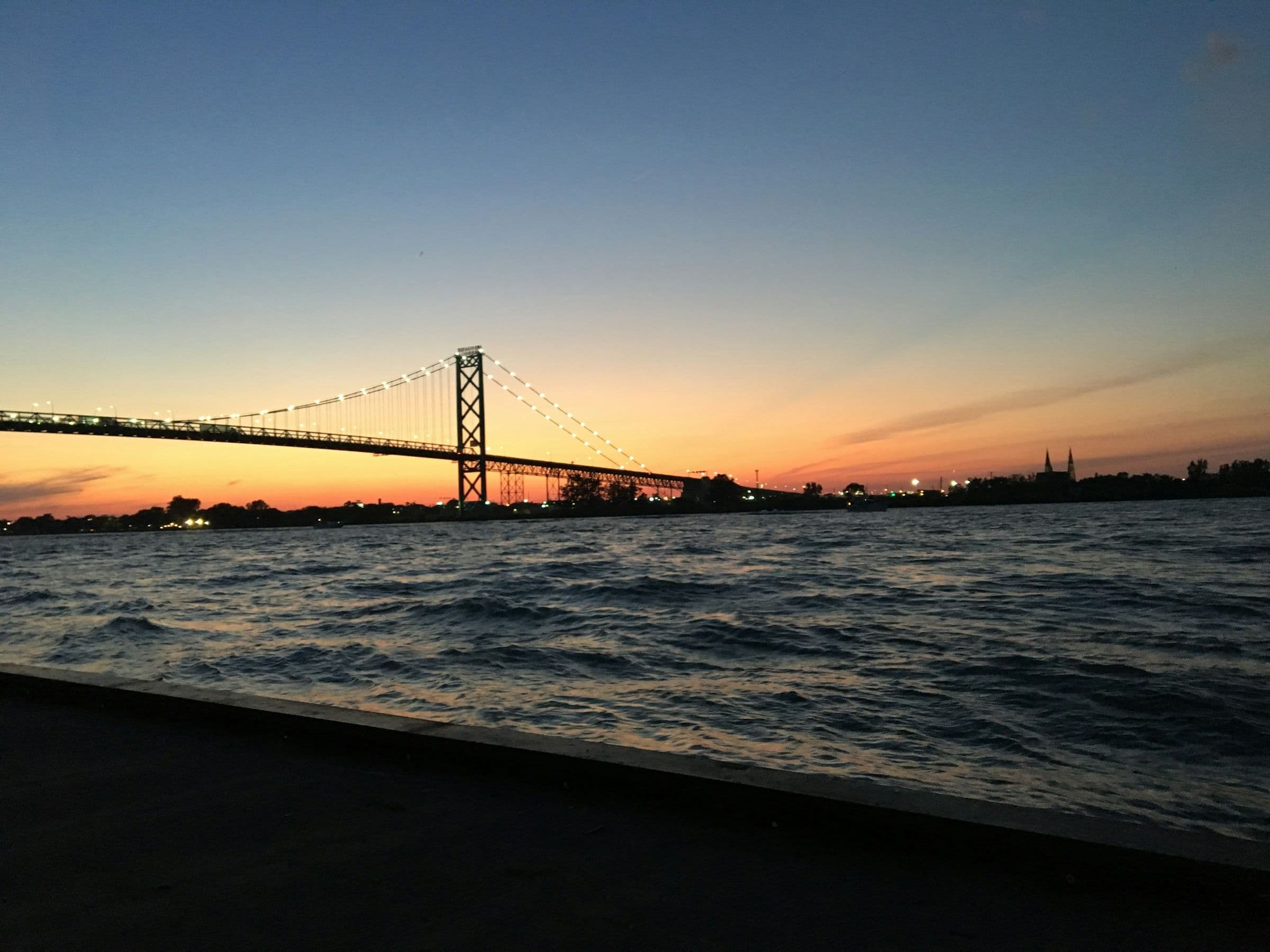 The Ambassador Bridge over the Detroit River at sunset